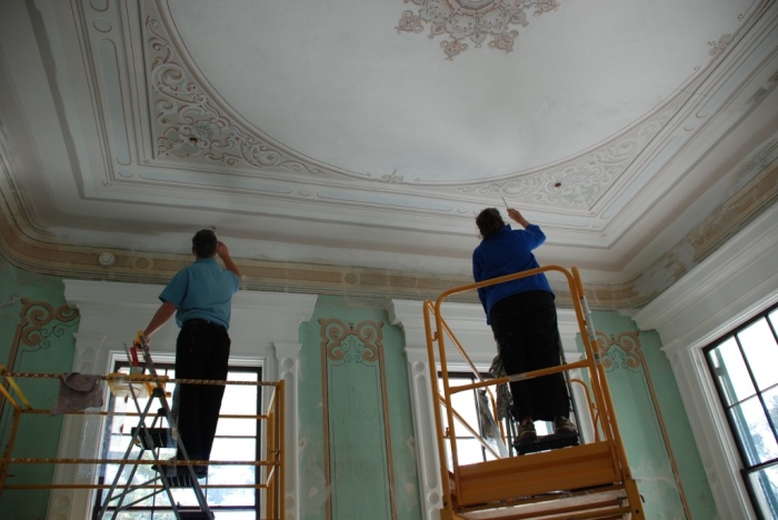 Artists re-touch and in some cases re-create the wall and ceiling "frescoes" in the main house