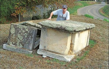 Figure 3. James Starnes behind box-grave monuments in the old Raymond cemetery made of Catahoula sandstone quarries at Mississippi Springs. Picture (color negative 601-24A) taken on December 19, 2006.