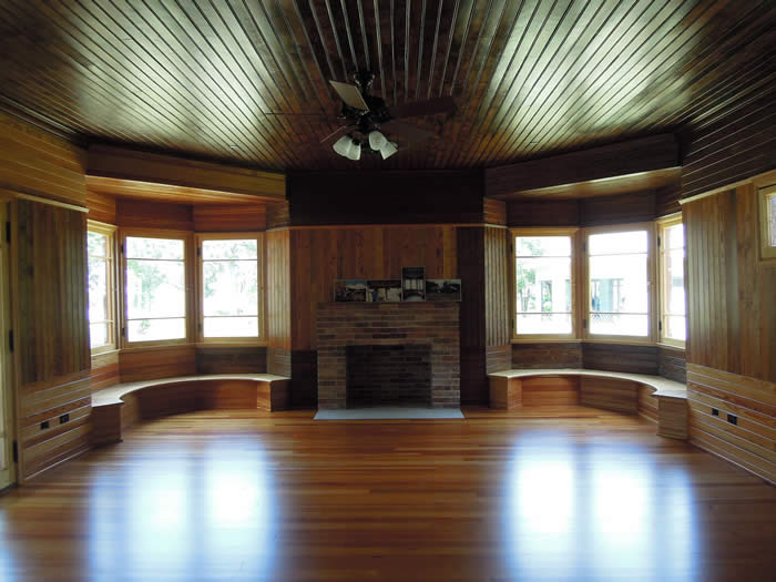 The Charnley-Norwood House is in a bungalow style built in a T-shape. The west bedroom shows how the generous window seats and windows bring in natural light which emphasizes the unique curly pine walls and ceiling. (Photo by Susan Ruddiman/Mississippi Heritage Trust)