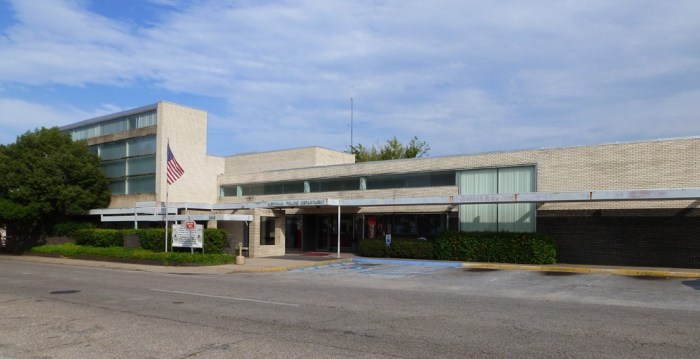 Meridian Police Station, Meridian, Lauderdale County. The Meridian Police Station is a one- and two-story brick-veneer steel structure renovated and expanded from an earlier laundry building in 1977 by the office of Meridian’s pre-eminent Modernist, Chris Risher, Sr. The long north façade faces the Beaux Arts City Hall across the street and helps define this two-block civic space. Risher’s signature black and white brick veneer emphasizes the building’s dramatic horizontal line, reinforced by a long covered walk that acts as a sun-breaker (brise soleil) for the large plate-glass windows. : As one of Mississippi’s most outstanding works of Modernism, the police station is of exceptional architectural significance at the statewide level. Recognized at its inception as a special work, and accepted for decades as the pinnacle of Chris Risher’s career, the building has also influenced many Mississippi architects who studied the building while at Mississippi State University. Designation requested by the City of Meridian. MDAH Board of Trustees designated the building on September 22, 2015.