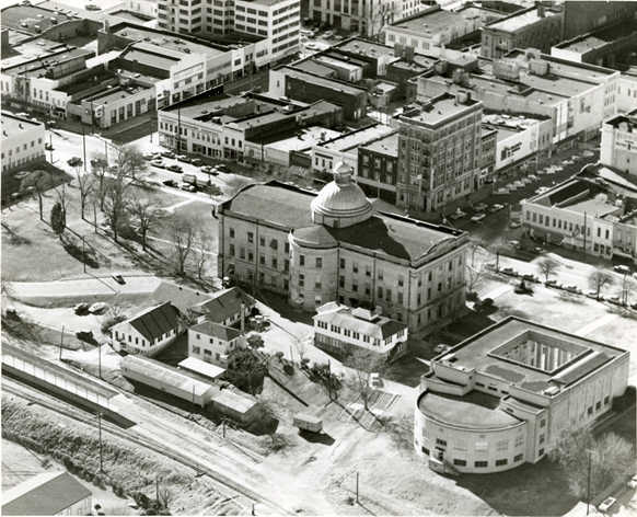 Item Number: 1 Image Date: 195- Creator: Hiatt Photo Service. Description: "Old Capitol, War Memorial Building." Aerial photograph shows east side of downtown Jackson with State St., Capitol St. and commercial buildings. City: Jackson. County: Hi Box Number: 476 Folder Number: 2